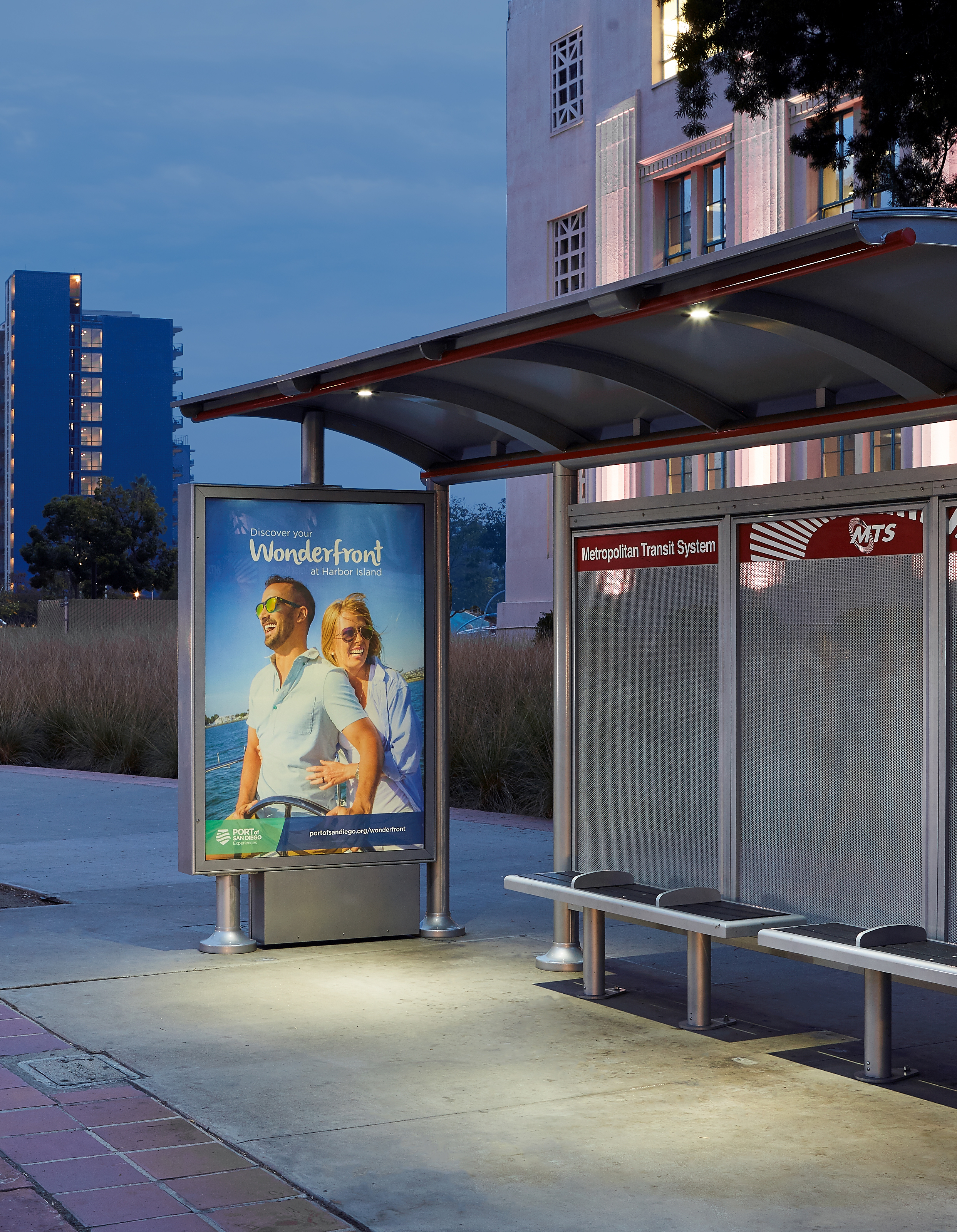 The PV-AD lighting illuminates a bus shelter advertisement.